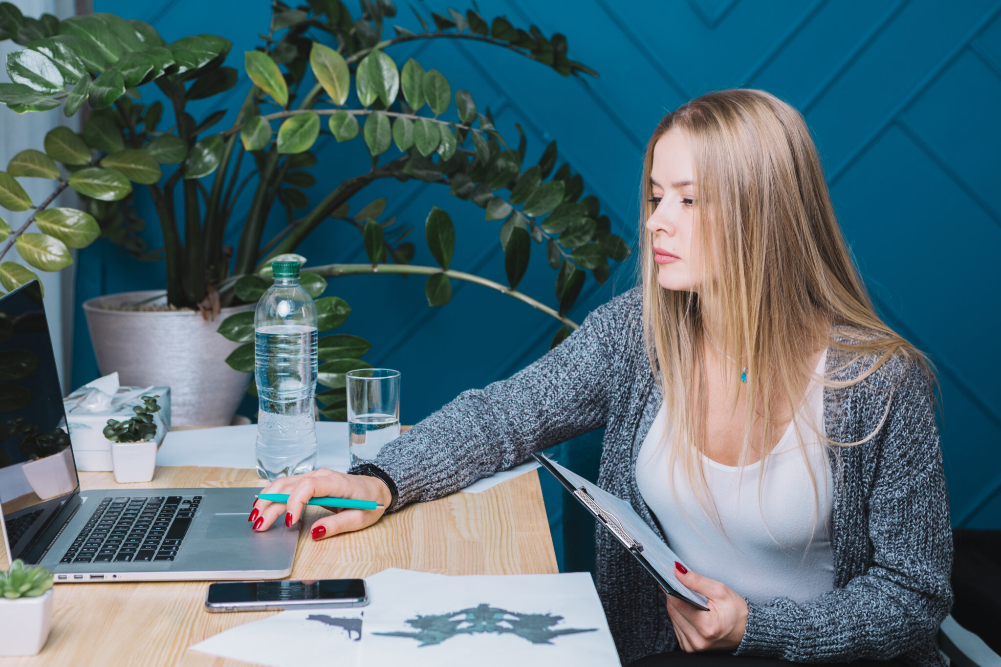young-blonde-female-psychologist-using-laptop-clinic